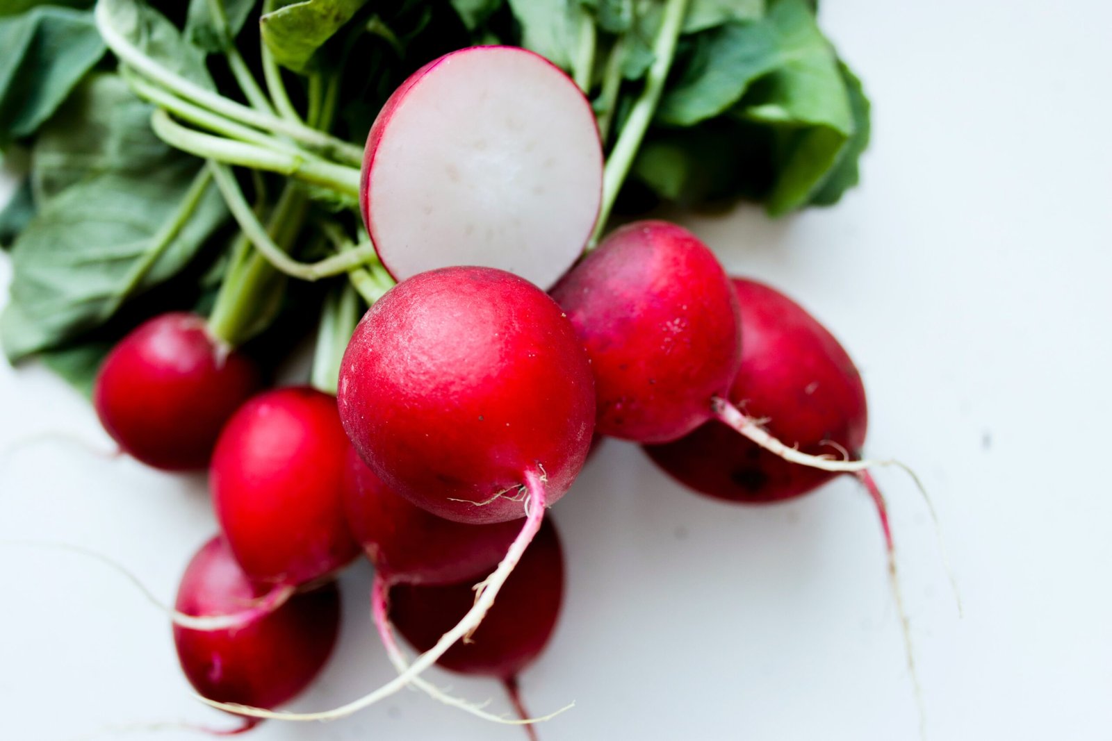 red tomato on white surface