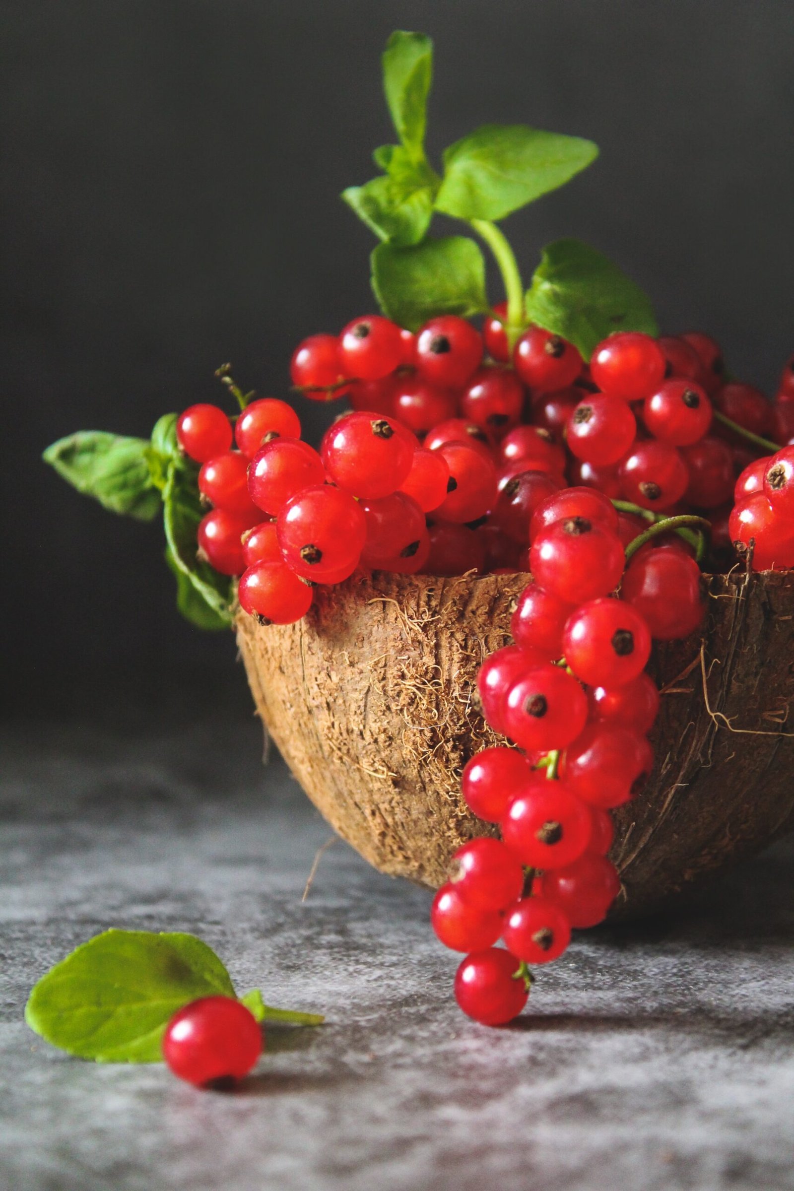 red cherries on brown wooden bowl